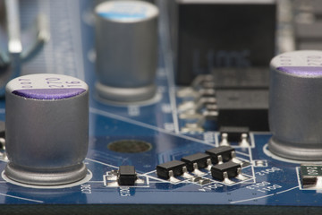 Electronic board. The board features elements: chips, diodes, capacitors, chokes. Shallow depth of...