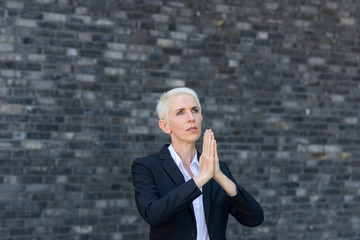 Praying woman with folded hands