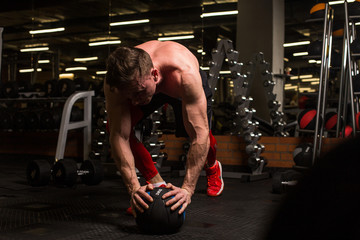 the sportsman is engaged in an exercise room, pumps muscles, a biceps and a press