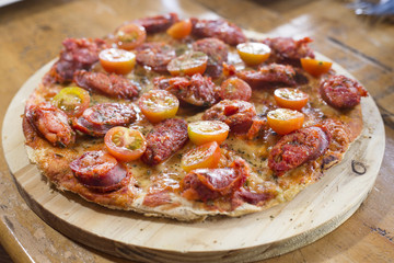 Delicious chorizo and cherry tomato pizza.