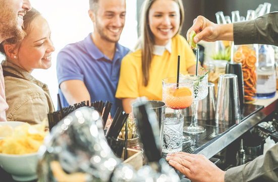 Happy young couples having fun at american bar in summer time
