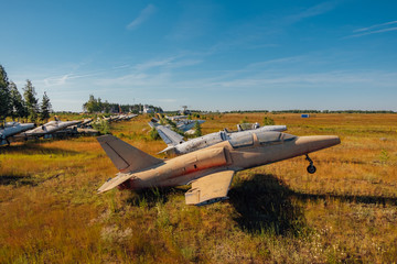 Abandoned broken old military fighter airplanes on grassy ground