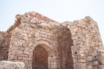Fototapeta premium Columns on the hellenistic stoa of the Acropolis of Lindos, Rhodes, Greece, Blue sky, olive tree and beatiful sea view in the background