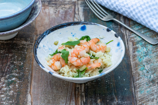 Prawn, fennel and rocket risotto on a table in the gargen. Outdoor dining.