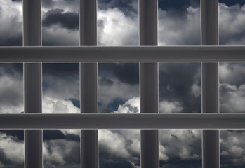 Prison window cell and cloudy sky