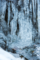 Fototapeta na wymiar Icicles on the stones ion cold winter