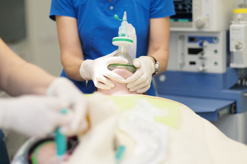 An anesthesiologists team enters the patient in general anesthesia before surgery