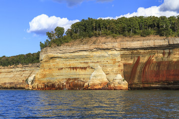 Fototapeta na wymiar Sandstone cliffs on the shoreline of Lake Superior in Pictured Rocks National Lakeshore, Michigan, USA