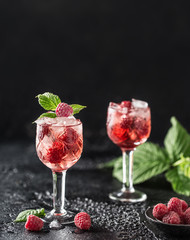 Fresh raspberry cocktail. Fresh summer cocktail with raspberry and ice cubes. Glass of raspberry mojito