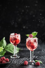 Fresh raspberry cocktail. Fresh summer cocktail with raspberry and ice cubes. Glass of raspberry mojito