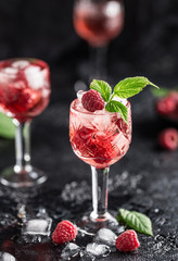 Fresh raspberry cocktail. Fresh summer cocktail with raspberry and ice cubes. Glass of raspberry mojito