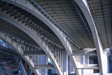 Empty street under a bridge in Lyon on a grey, winter day in February.