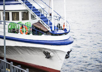 Naklejka premium the bow of a traditional wooden boat with teak deck, hardwood bowsprit with blue sea.