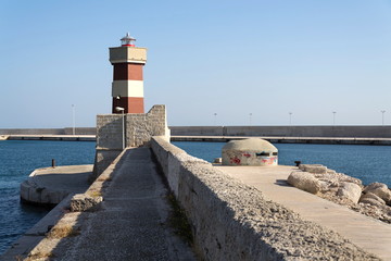 Lighthouse in Monopoli port in front of Castle of Carlo V, Adriatic Sea, Apulia, Bari province,...