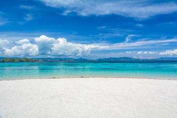 Fototapeta na wymiar White Sand Beach with Two Different Color of Clear Turquoise and Blue Sea at Kanawa Island, Komodo National Park, Labuan Bajo, Indonesia