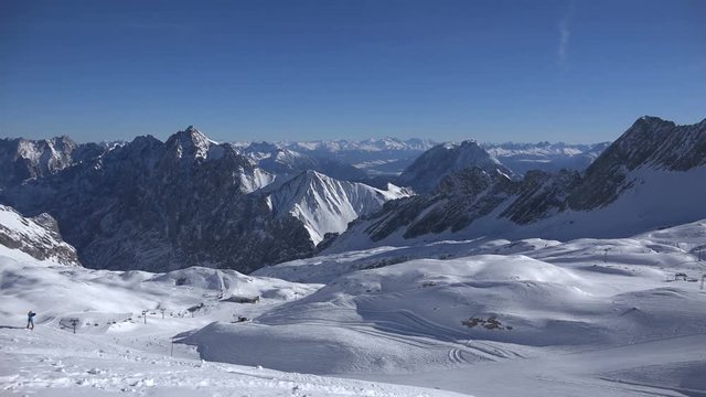 Panning shot over the lower part of the ski resort Zugspitze as seen from the Zugspitzplatt, central hub for all skiing lifts and the Zugspitz train glacier station.