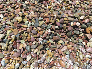 Smooth polished stones on a lake's shoreline