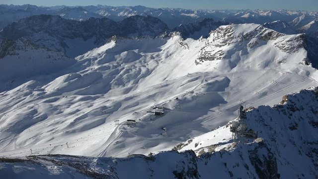 The alpine panorama seen from the summit of Germany's tallest mountain, the Zugspitze, looking southwest including the skiing resort on the Zugspitz glaciers, shot on a beautiful winter's day.