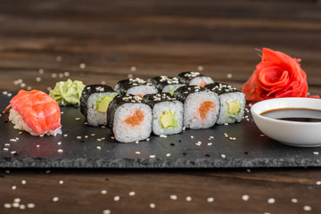 Fresh and tasty sushi on dark background. It can be used as a background