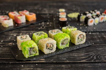 Fresh and tasty sushi on dark background. It can be used as a background