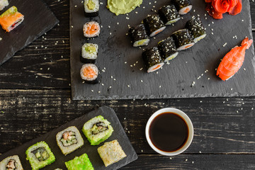 Fresh and tasty sushi on dark background. It can be used as a background