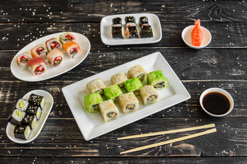 Fresh and tasty sushi on dark background. It can be used as a background