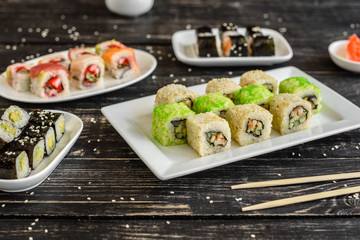 Fresh and tasty sushi on dark background. It can be used as a background