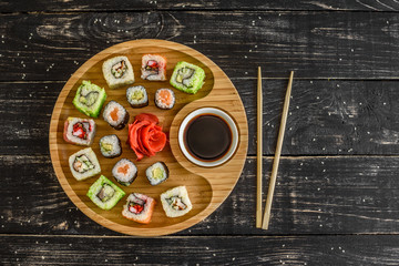 Fresh and tasty sushi on dark background. It can be used as a background