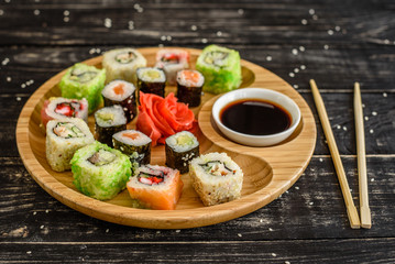 Fresh and tasty sushi on dark background. It can be used as a background