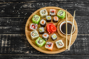 Fresh and tasty sushi on dark background. It can be used as a background