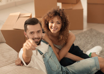 young couple holding the key to a new apartment