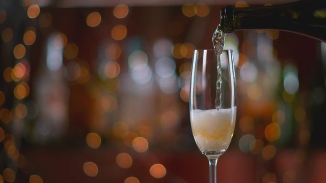 Champagne pouring into glass in super slow motion. Shot with high speed cinema camera, 1000fps.