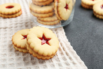 Traditional Christmas Linzer cookies with sweet jam on table