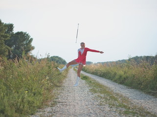 Teen Majorette Girl Twirling Baton Outdoors