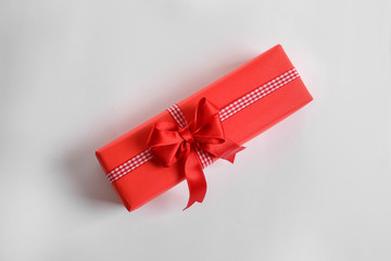 Beautifully wrapped gift box on white background, top view