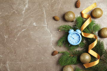 Flat lay composition with alarm clock, fir branches and decorations on grey background. Christmas countdown