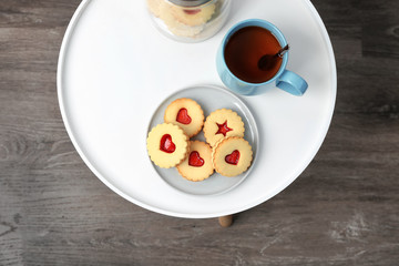 Traditional Christmas Linzer cookies with sweet jam on table, top view