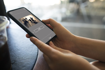 using a phone in a street cafe