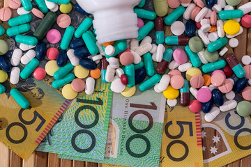 Colorful tablets with container and australian dollars
