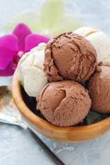 Homemade vanilla and chocolate sundae in a wooden bowl.