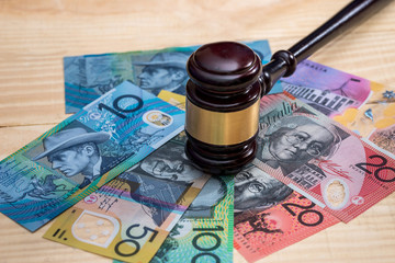 Judge's gavel on australian dollar banknotes closeup
