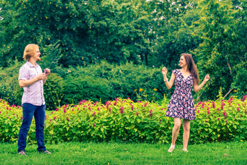 Couple blowing bubbles outdoor