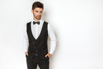 Strong commercial male model face in tuxedo on white background