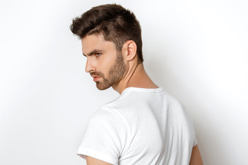 Strong face male model in casual style in white t sirt and jeans on white background