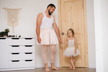 Little daughter and father have fun, dressing in princess costume, daddy makeup