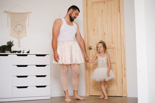 Little daughter and father have fun, dressing in princess costume, daddy makeup
