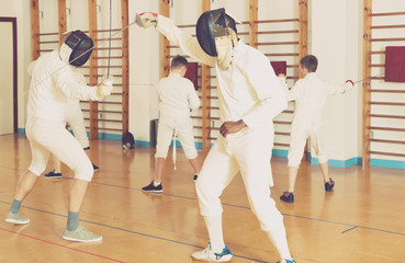 fencers exercising attack movements in duel