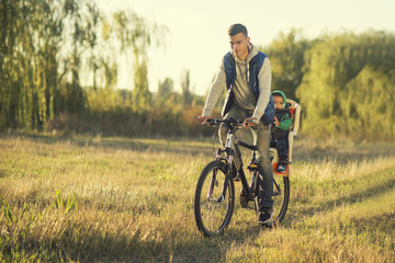 concept of father's day. loving caring dad walks in the park with his 2 year old son