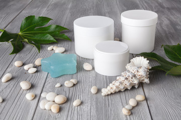 Spa procedure concept, different cosmetic jar and bottle on wooden table