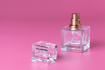 Obraz na płótnie Canvas A glass perfume bottle, a female fragrance, an accessory for beauty